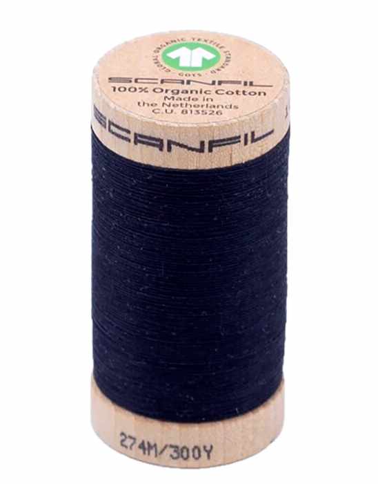 Spool of dark blue thread with a beige label on a white background